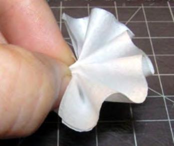 Separate folded halves of tissue to create fluff and volume. 6.