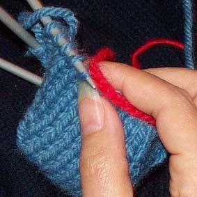 Stick the point of the third dpn in the stitch below the chain.