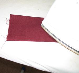Turn the fabric right side out and press the seam and folded