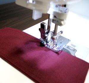 Sew a 1/4 inch top stitch along the seamed and folded edges of