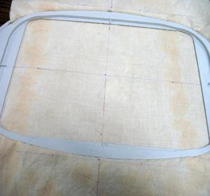 Hoop the center design with cut-away stabilizer that has been sprayed with temporary adhesive.