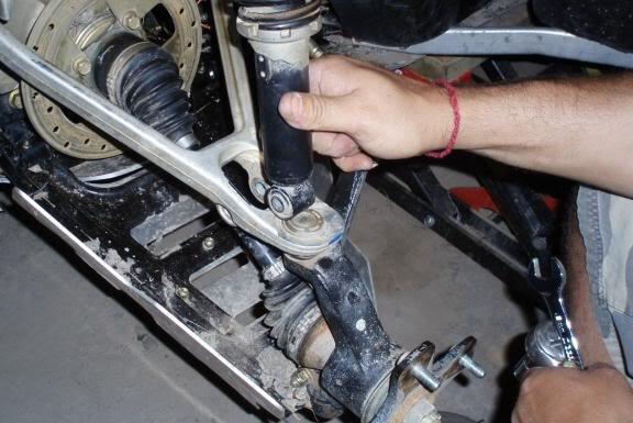 (machine pictured above is an Outlander, but the same principals apply) -Place a front lift block into the lower shock mounting slot making sure to keep the factory bushings in place and use the