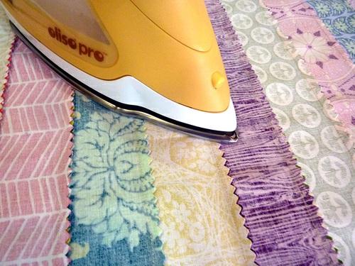 Slice the patchwork into horizontal strips and complete the center band 1. Take the completed patchwork panel to your cutting surface.