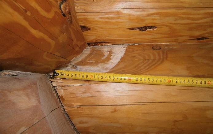 Significant damage occurred at the bottom log connection to the concrete slab, especially where there was a bottom half-log.