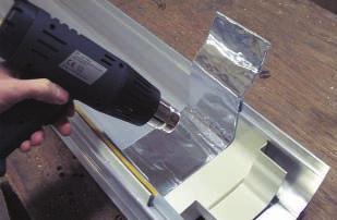 Apply the supplied specialised tape centrally over the visible joint and cut it to size.
