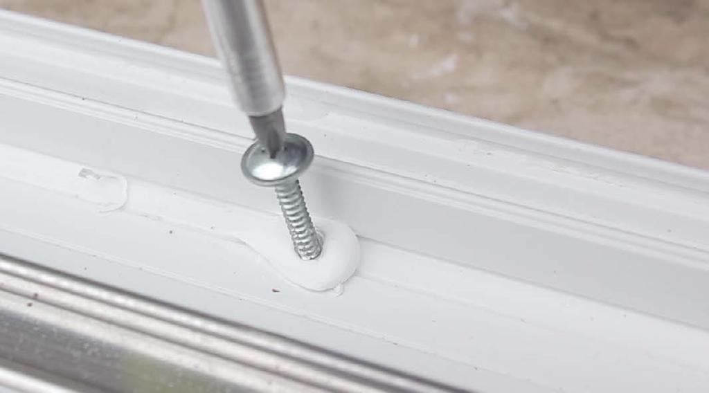 16 Use appropriate fixings to secure down through the centre channel of the PVCu outer frame.