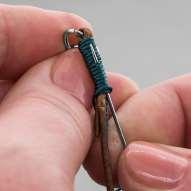 Hold the tail end of the bead cord in between and parallel with leather cord strands