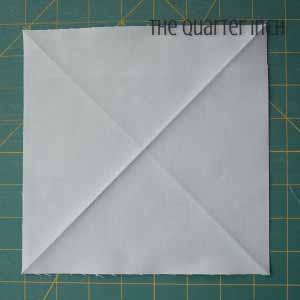 1. From the background fabric, cut [42] 7½ squares. 2. Iron two creases diagonally across each square. These will help you place the orange peels. 3. Make a template using the diagram below.