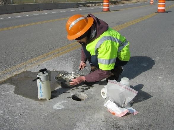 patched concrete for waterproofing, shown in Figure 19. The rest of the hole is filled with an asphalt patch material, shown Figure 20.