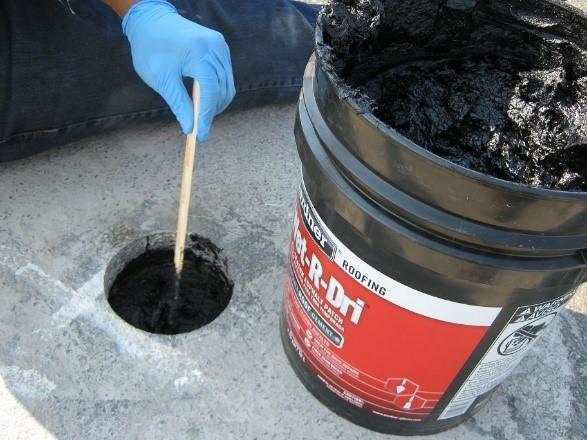 Figure 21. Compacting the asphalt patch material requires a fair amount of physical strength and endurance.