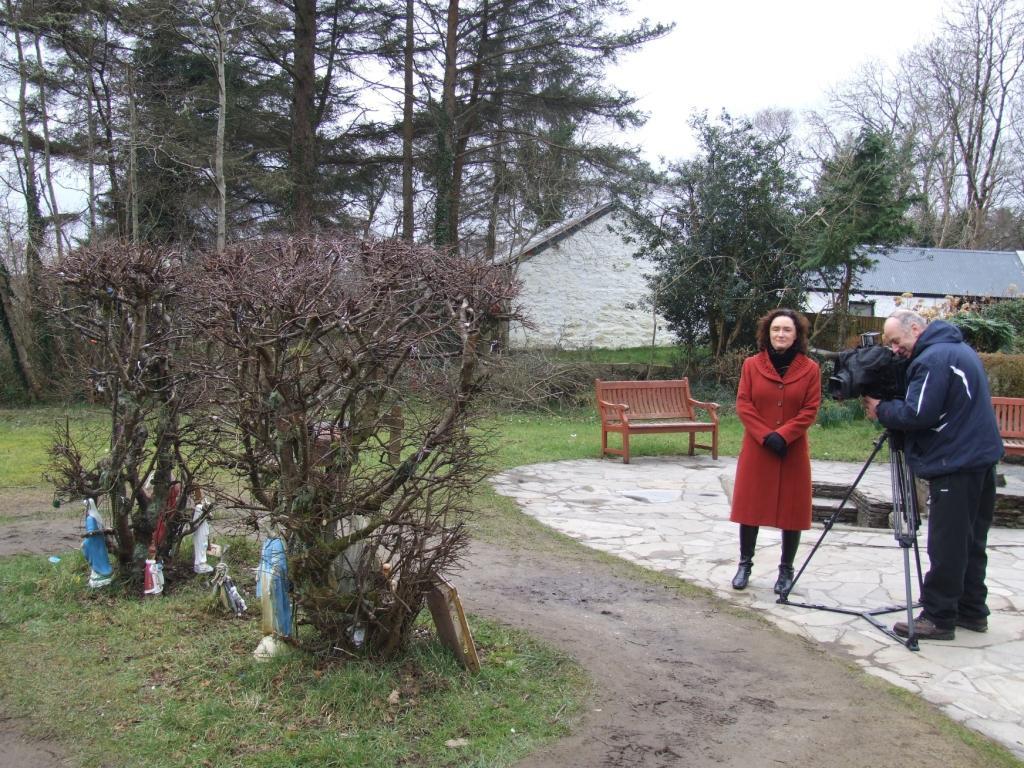 County Donegal Heritage Office Review of 2013 Eileen Magnier, North West Correspondent, RTÉ with cameraman John McMorrow at Doon Well (near Kilmacrennan) filming part of the feature on the survey of