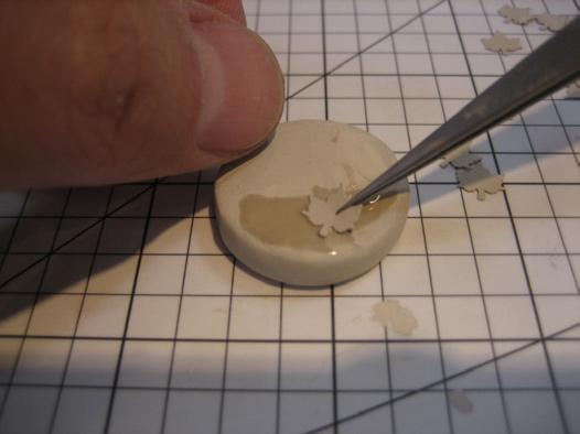 (photo 4) To apply the leaves to the bead, first wet the bead with a little water to Photo 3 activate the binder in the clay.