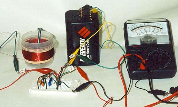 Figure 9. Photograph of amplifier circuit connected to magnet and coil assembly to provide input signal and multimeter to view output signal.