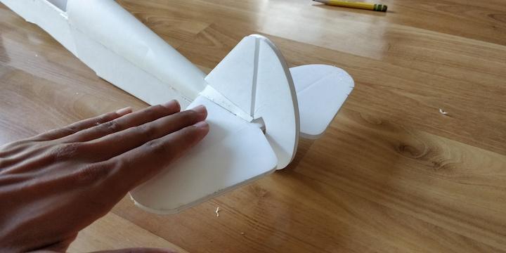 Repeat the same process on the other side. Lastly, glue down the tail ends of the turtle deck such that at the very back, they meet flat against the horizontal stabilizer.