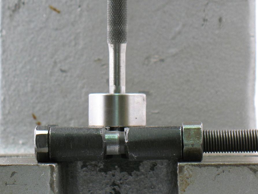6. Use a 5/16" or 8 mm diameter flat-end drive punch as