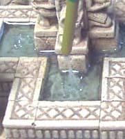 Stir it slowly and try not to work any excess air into the glue. Add a large bead of it to each of the fountain pools. Do not do more than 4 small pools at a time.