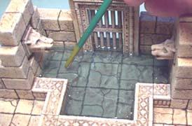 By this time, the epoxy should be starting to thicken up. Find where you think the stream of pouring water should be hitting the pool below and add texture to that spot.