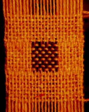Figure 4: Doubleweave sample with a solid color plain weave fabric twice intersecting a striped plain weave fabric. m n fundamental block.
