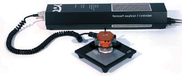26 Figure 2.8: Nanosurf s easyscan commercial AFM system [1]. The photo shown here is borrowed from the citation. The easyscan AFM package shown in Fig. 2.8 consists of a control box, scanning head, and sample platform.