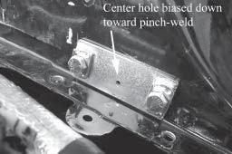 The flat side should be against the firewall, with the nuts toward the rear of the car.