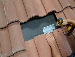 Use pry bar to remove roof tile where the base will be installed.