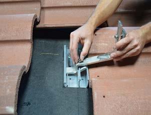 2) Align the base over the rafter so the hook can enter at the valley of a tile and not extend beyond the edge of the base.