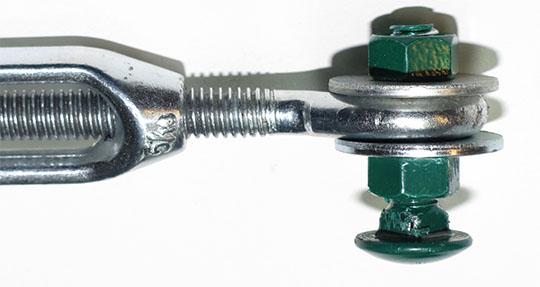 11. One 2 ½ x 5/16 carriage bolt, two 5/16 nuts and two large 5/16 ( fender ) washers were tightly attached to one end of the turnbuckle. (photo below) 12.