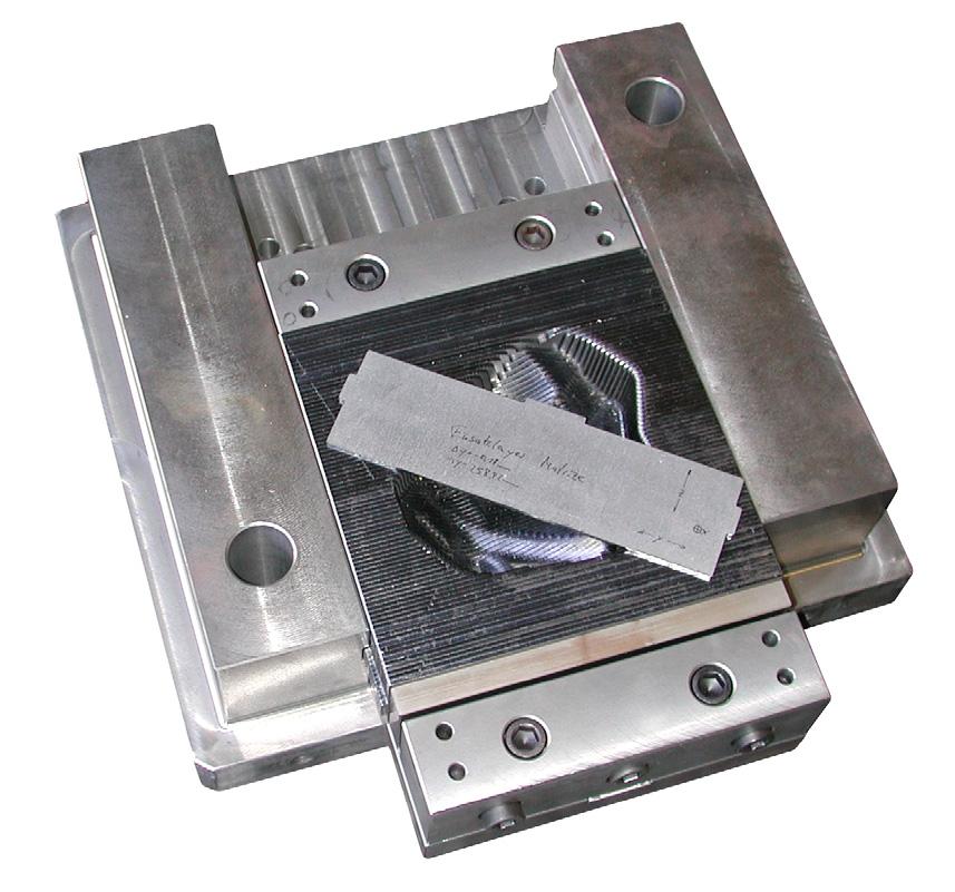A module consists of the tool frame, the laminated free form surfaces and a 2-chuck jaw block that can be taken out from the frame. Only this block is removed from the frame for finish machining [5].
