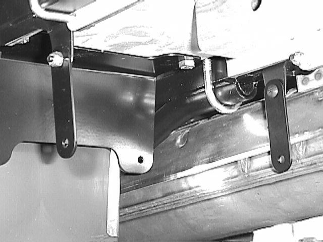 Use the two small Black Phillips Head screws provided and #10-32 Nylock Nuts to secure the straps as shown. The heads of the screws should be toward the inside the frame. 8.