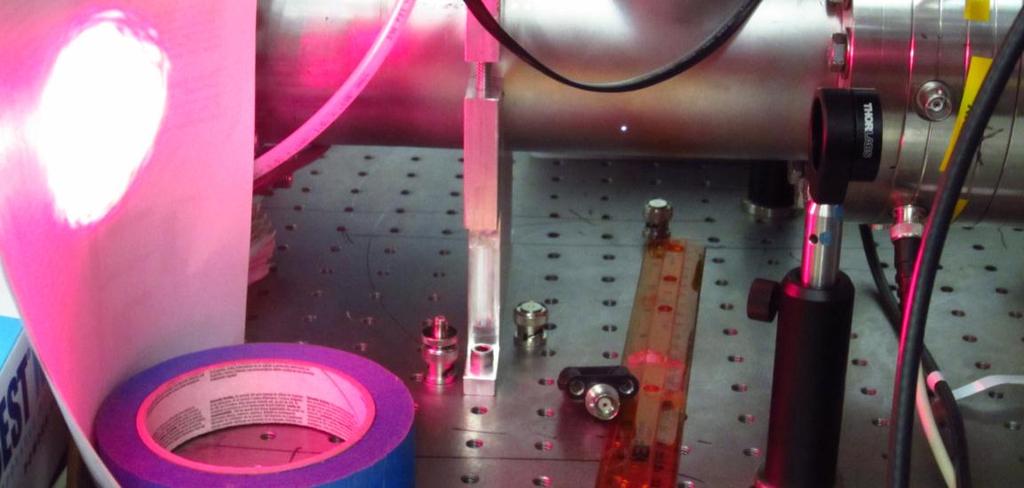 Figure 10. A TLP can ionize air when the laser grating is at the optimal position. The full powered ultrafast laser beam was sent through the focusing Thor labs lens on the right.