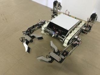 In order to enable the robot to grip variety shaped objects as well as walk by four legs, the hand unit needs to have not only wide palm but also let the tip of the leg touch the ground firmly.