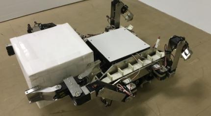 The handling tasks of sphere-shaped object by two robotic arms, which has not been able to perform by the arms in original mechanism, were successfully performed by the developed hand mechanism.