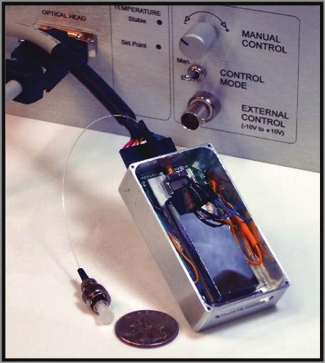 Figure 9: Example of prototype device construction and packaging. The LC-waveguide EO beamsteerer is mounted on a ceramic base, which also holds input coupling optics and an output collimation lens.
