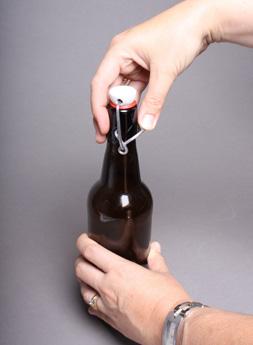 When the bottle is almost full, with about 1/3 of the neck as headspace, close the black beverage knob
