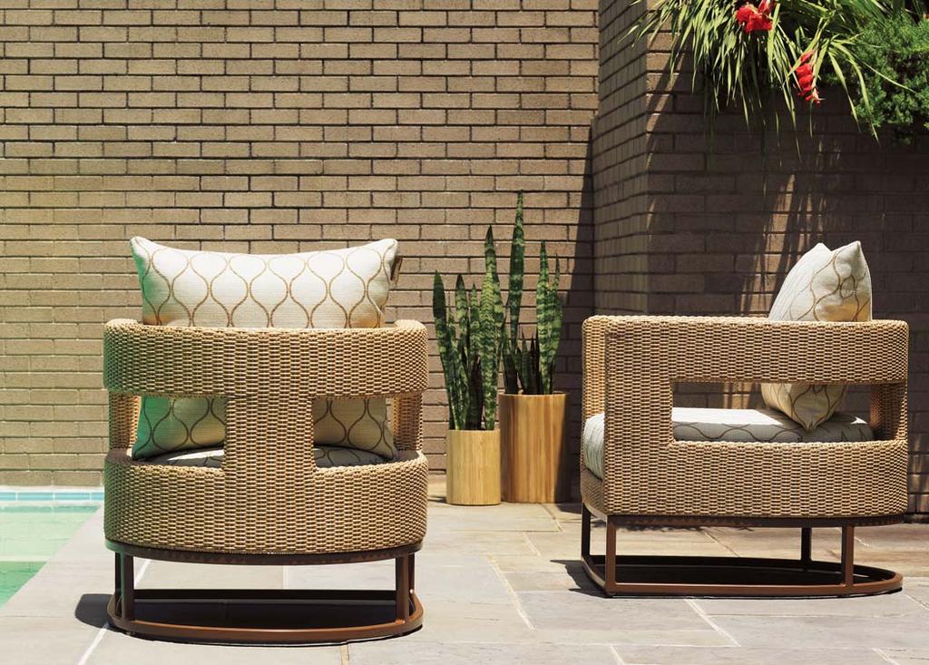 The graceful barrel-back lounge chair features an open back and sides, offering a