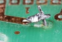 3. Once the solder is removed from around the pin and the output pad, you can remove the wick from the board. Remove the wick first, then remove the iron.
