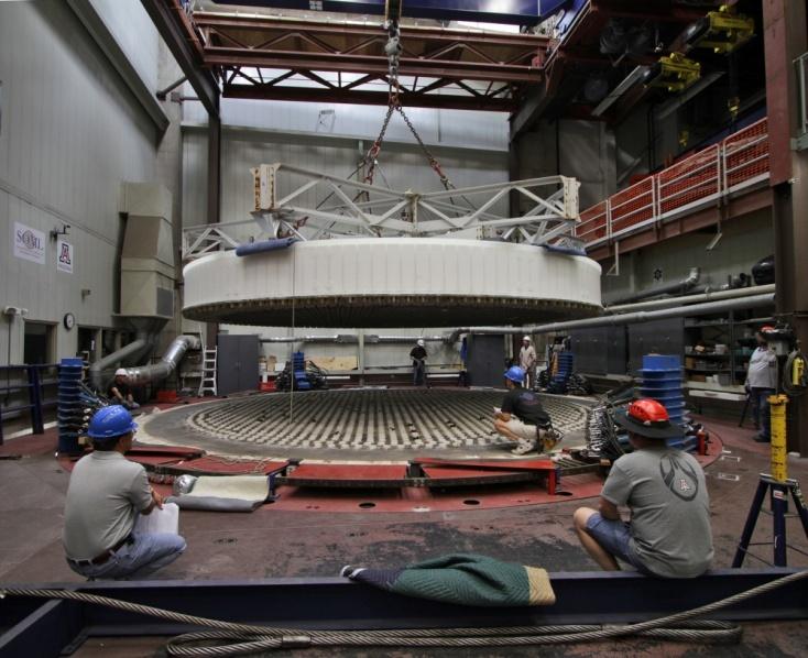 Figure 11. Left: Segment 2 being lifted off the furnace following the casting. Right: the segment in its turning ring, being rotated into a vertical plane for removal of the mold parts.