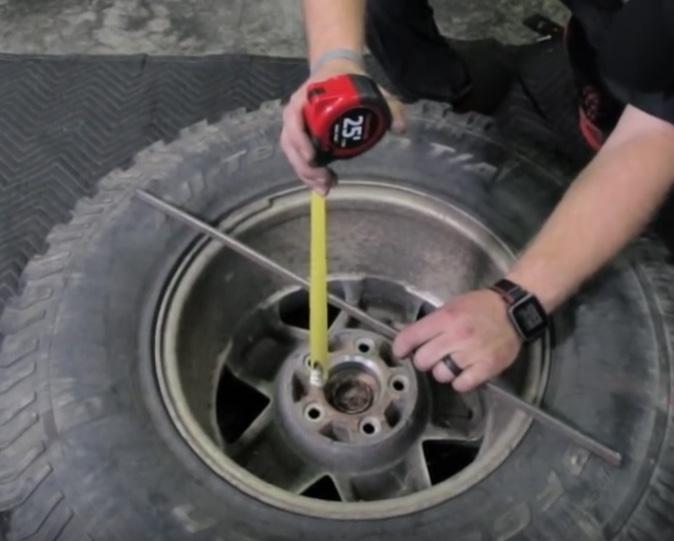 10 To find the correct backspacing or depth that the tire mount needs to be set at, use something flat to lay across the back of the tire.