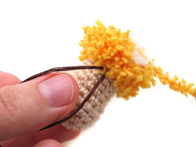 Push the needle back to the bottom of the head. If you have left the yarn end at the beginning tie two tails together with a few knots.