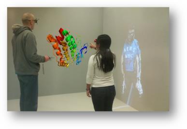 Figure 4: Collaboration in an Immersive Display System Figure 5: Collaboration in a non-immersive display system. Example shown is video avatar projected in the space.