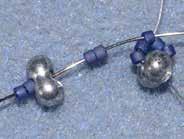 Note: adjust the D11 beads to make an inverted V. [photo 2] Pick up 2 D11 + 1 F + 2 D11.