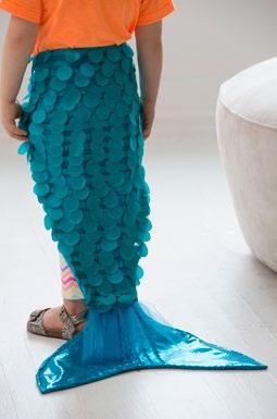 Cutting From the turquoise sparkle knit, cut: 2 tails 2 tail fins 2 hoods From the turquoise scaly fabric, cut: 2 tails Note: The scales should be facing downward on the tail.