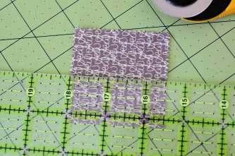 4. Cut your sashing squares in half: each sashing strip will measure 2.5" x 1.25" (with about 0.