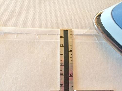 against the inner fold of the narrow hem. The top, bottom, and outer edges of the interfacing should be flush with the raw edges of the underlap panel. 5.