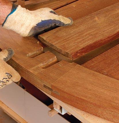 Adjust the trammel and rout the tenons to length. Cut a deep groove 8 in. out from the tenon shoulder, stopping short of routing all the way through the boards.