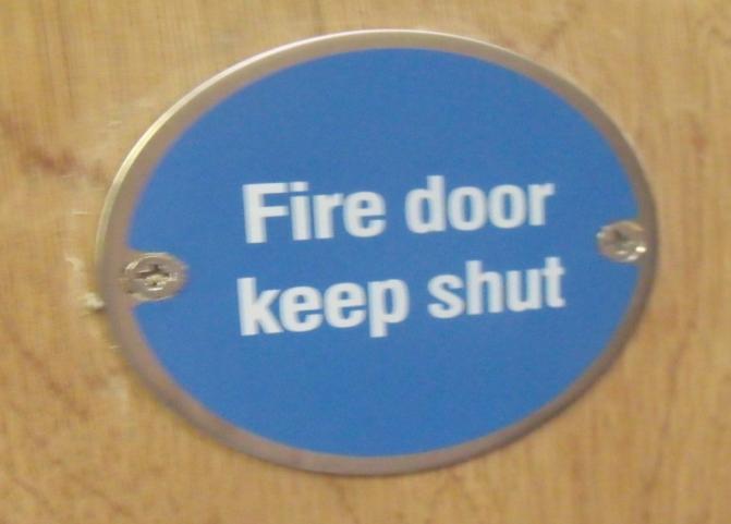 kept locked when not in use (Fire door keep locked) or held open by an automatic release system or free swing device (Automatic fire door keep clear).