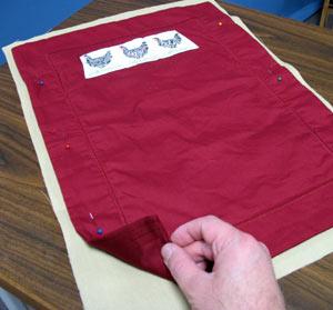 Lay the lightweight canvas lining flat and lay the placemat on top, right side down.