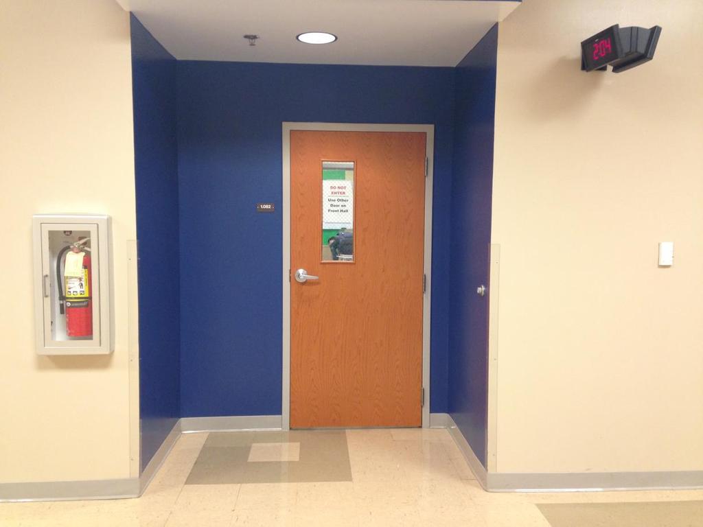 The hallway in RCA is a neutral color and the one area around the door is blue