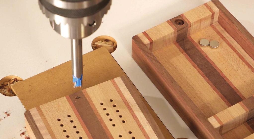 Use a push block with a sacrificial backer board to push the assembly through the cut and prevent blowout as the bit exits