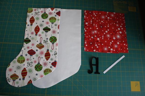It takes 1 FQ for each stocking, and 1 produces 2 cuffs. First, iron the cuff pieces in half. Then iron on your applique.